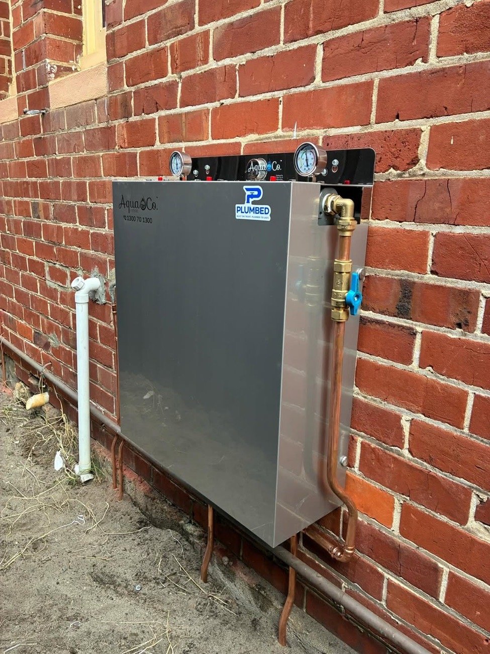 AquaCo filtration system installed on a brick wall